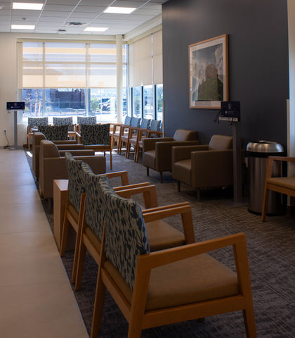 Lobby in a medical clinic, featuring motorized roller shades in an off white color