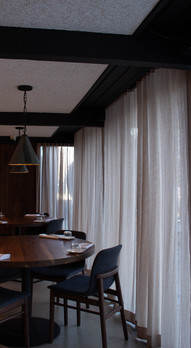 Interior dining room at Uchiko sushi in cherry creek .minimal modern sushi bar. featuring wood decore, modern vibes and cool plants.