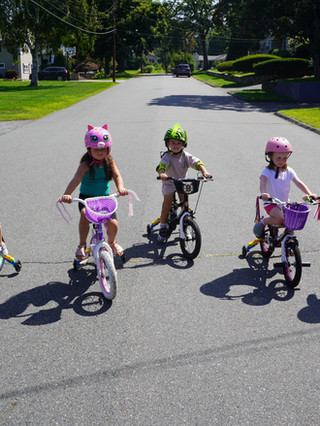a group of kids biking on an empty street