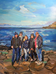 Group of friends posing near the ocean against a blue sky background. Téa's Portraits