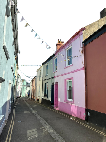 Colorful terraced houses on a narrow street with bunting