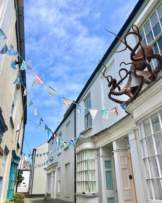 Street with bunting and octopus sculpture on building