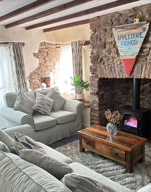 Cozy cottage living room with stone fireplace and wood burner