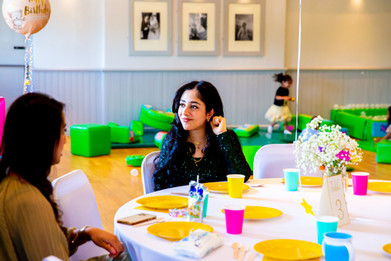 Birthday party photographer takes photos of guests having a conversation
