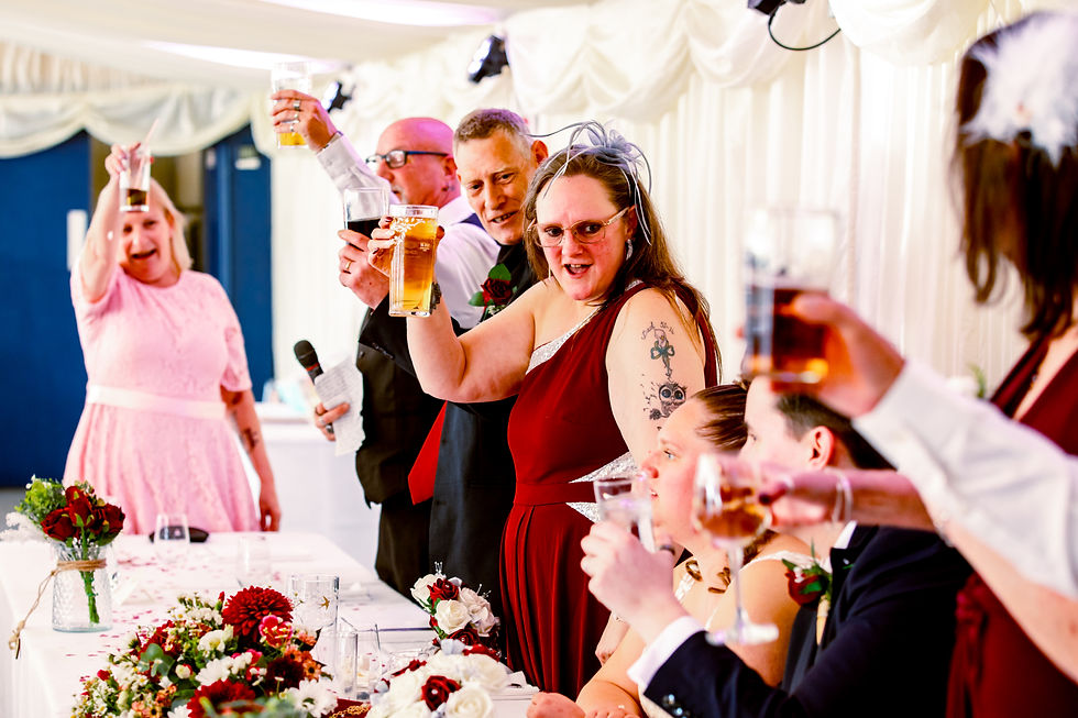 mother of the bride raising her glass to the bride and groom