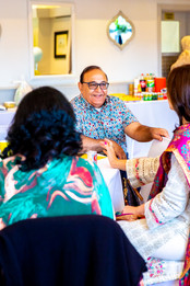 Candid party photo of guest chatting at a birthday party 