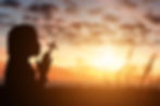 silhouette-of-little-girl-holding-christian-cross-in-hands-to-praying-for-blessing-from-go