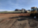 graded homesite with rock retaining wall and equipment