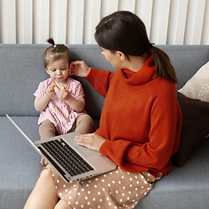 A young mother distracted from her writing by her little girl