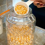 HAND SCOOPING KERNELS FROM LG JAR.jpg