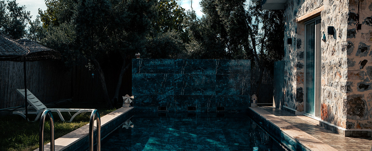 A stone house and a blue pool - architectural photography