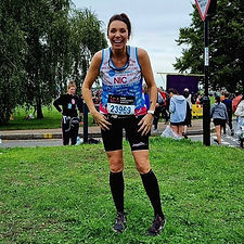 Smiling runner wearing Ease Pocket Shorts at a marathon.