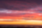 Figure 2. Glowing clouds over the eastern plains of Colorado about 10 minutes before the almanac time of sunrise, taken from the summit of Twin Sisters, Rocky Mountain National Park, Colorado.