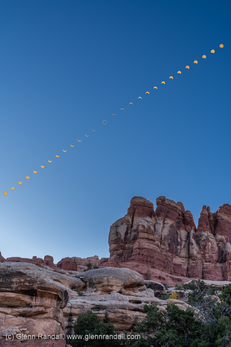 The sun rises over towers in Devils Pocket, Needles District, Canyonlands National Park, Utah, during the annular solar eclipse of October 14, 2023