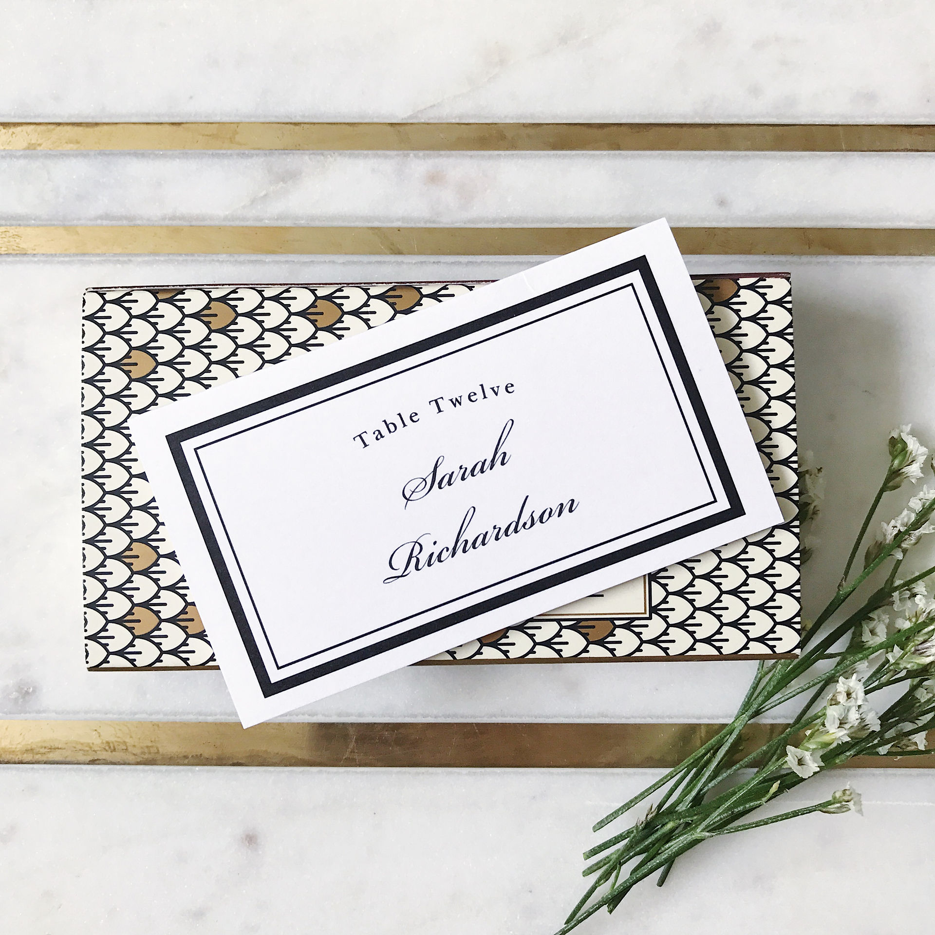 White and green color scheme showing custom made name tags, table number, gold wedding silverware, elegant cloth napkin, and table place setup. #weddingcolors #weddingcolorscheme #weddinginvitations #customweddinginvitations #savethedate #savethedatecard #savethedatepostcard #weddingwebsite #weddingsilverware #nametag #weddingseating #weddingassignedseat