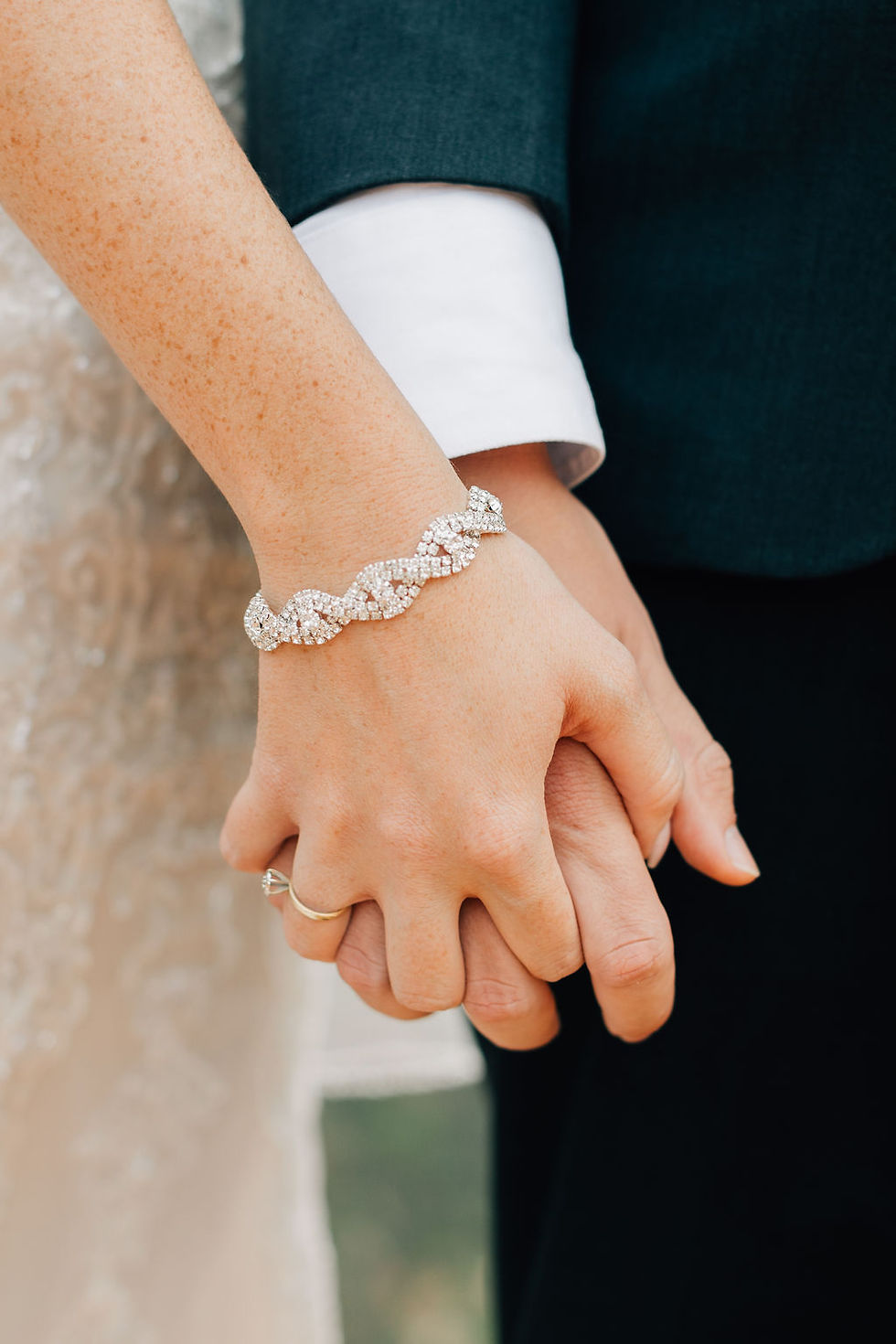 Bride and groom holding hands at alter with diamond bracelet and shiny diamond wedding ring. #wedding #utahwedding #zionwedding #bohowedding #destinationwedding #southernutahwedding #eventcoordintor #ido #intimatewedding #elopement #zionweddingplanner #utahbride #outdoorwedding #weddinginspo #weddingdayready #destinationelopement #weddingtips #weddingdetails #zionbride #bohobride #brideandgroom #destinationweddingcoordinator #sohitched #weddingday #yourbigday #holdinghands #forever #diamondring #weddingring #diamondbracelet #betweddingplannerinsouthernutah