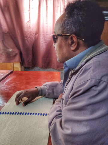 Blind man reading Braille