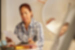 Picture of a woman reviewing paperwork.