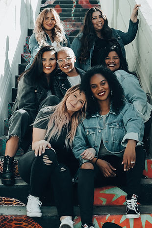 5 women sitting on a staircase