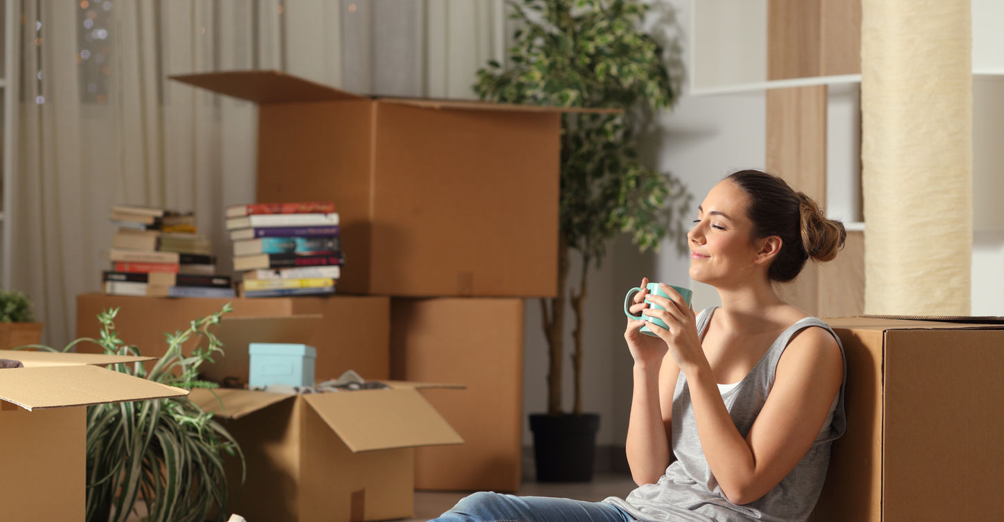 Happy tenant moving home resting breathing fresh air sitting on the floor in the night.jpg