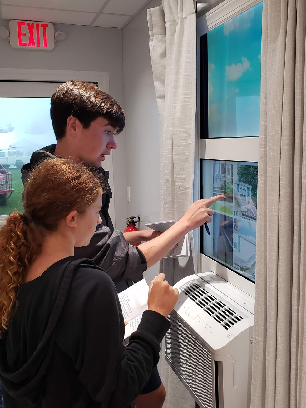 Siblings play a game hidden inside a window frame