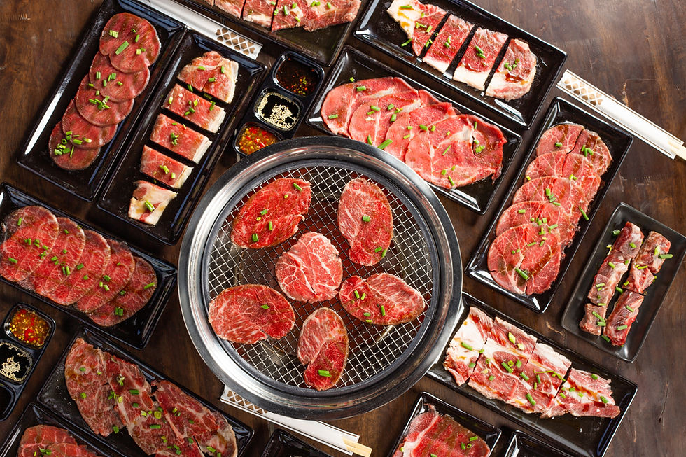 Raw beef slice for barbecue japanese style, yakiniku. Meats are being cooked on the stove