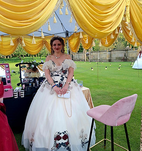Bespoke wedding entertainment showing a guest getting elegant cosmetic body glitter application to match her formal white evening gown