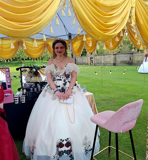 Bespoke wedding entertainment showing a guest getting elegant cosmetic body glitter application to match her formal white evening gown