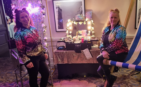 Pop up glitter bar with sequin wall backdrop and LED lights. 2 glitter painters for corporate staff party