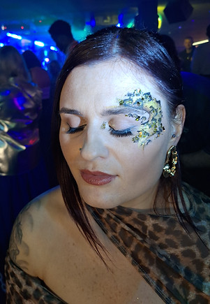 Glam girls with festival glitter painted faces celebrating at a hen party with the Hollywood Glam mobile glitter bar hire by Event Buddies Scotland.