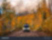 stock-photo-campervan-driving-wild-forest-road-with-headlights-on-epic-autumn-fall-foliage