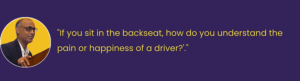 Smiling person with a colorful scarf on a yellow circle backdrop. Quote: "The foremost trait I look for is empathy, followed by humor and an entrepreneurial spirit." Navy background.