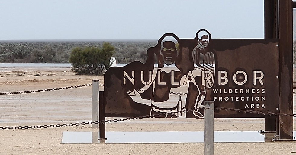 iron sign beside road