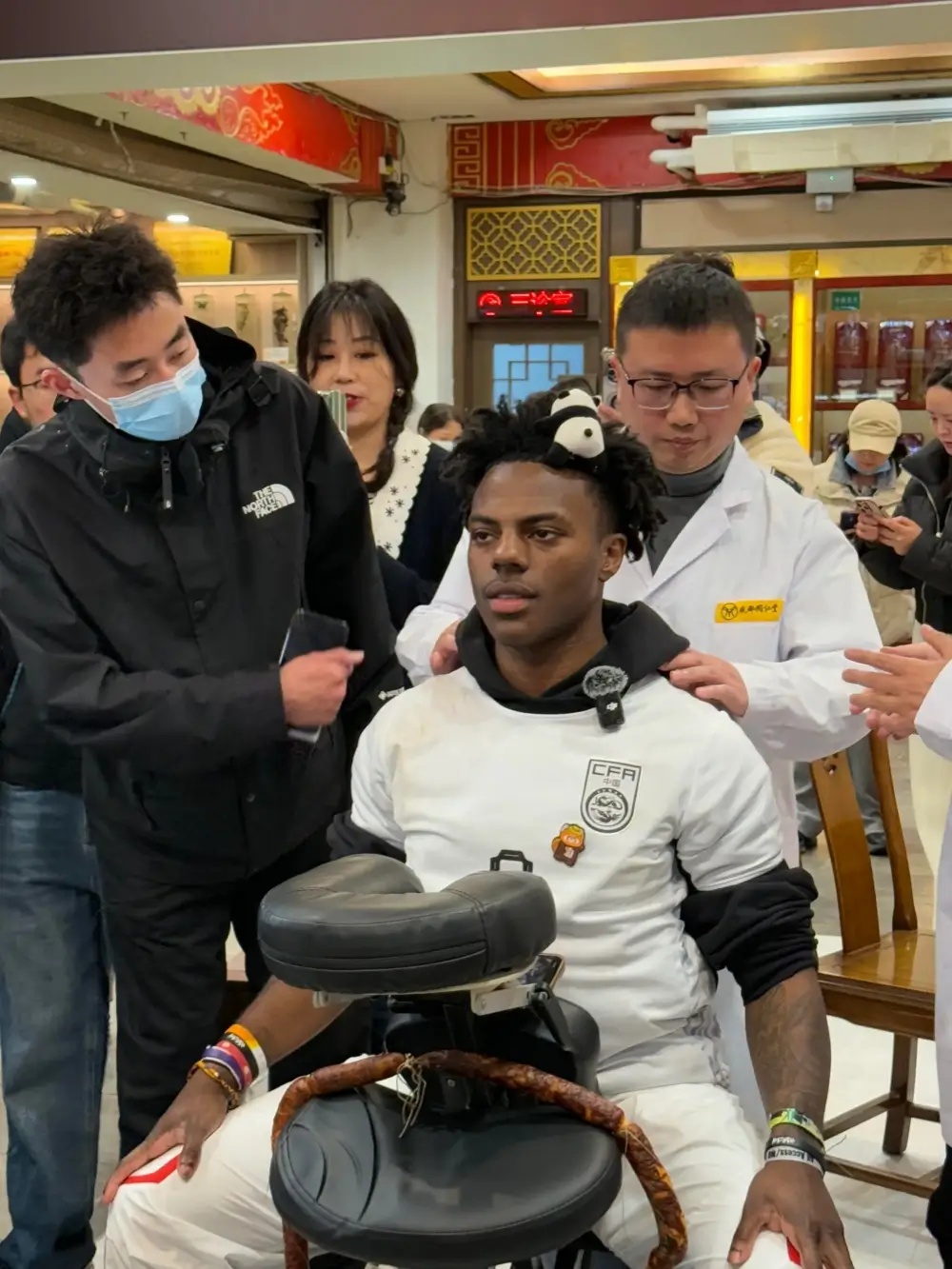 Foreign visitor experiencing a Traditional Chinese Medicine consultation in Beijing with guidance from a TCM practitioner