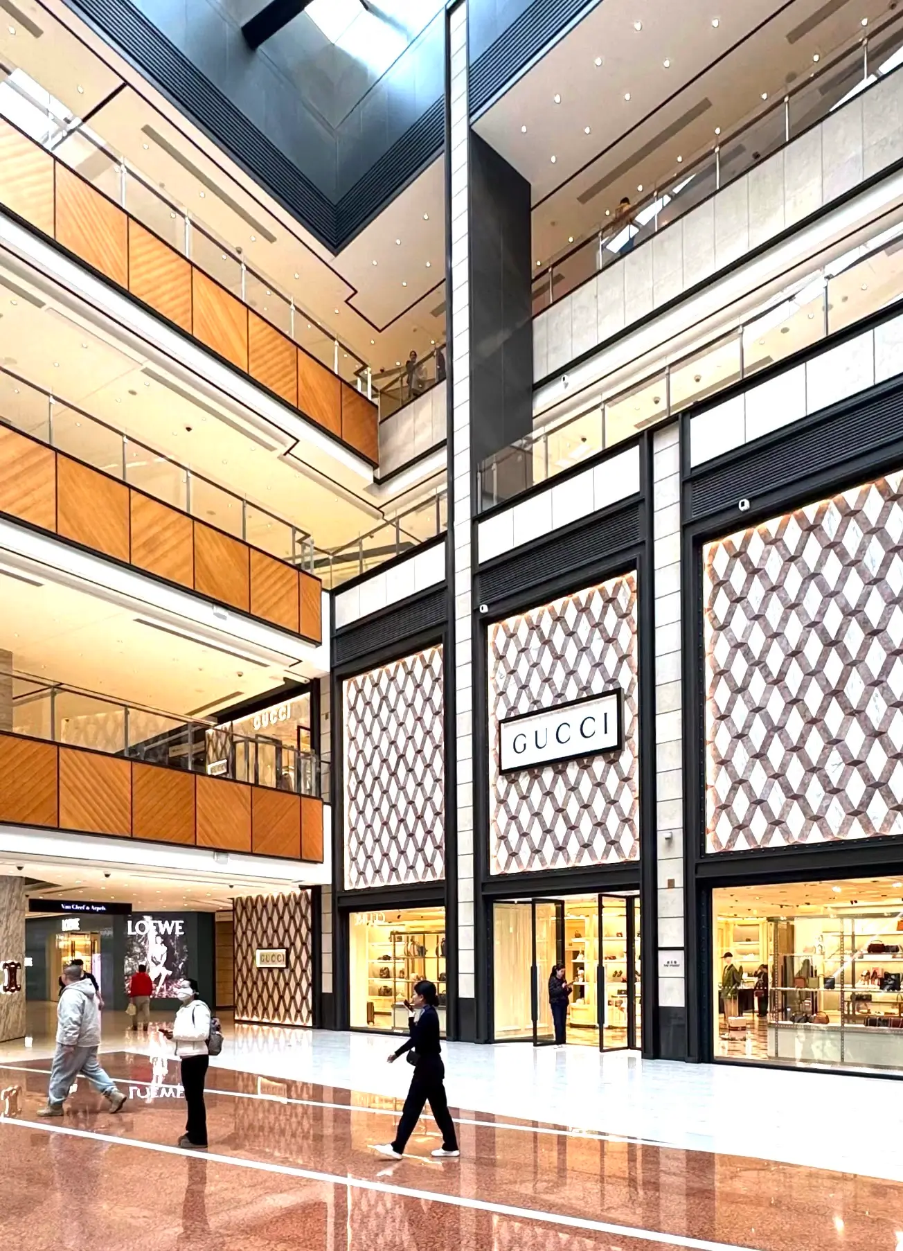 Luxury shopping interior at China World Mall in Beijing, featuring flagship stores like Gucci and Loewe in a modern high-end Beijing shopping environment.