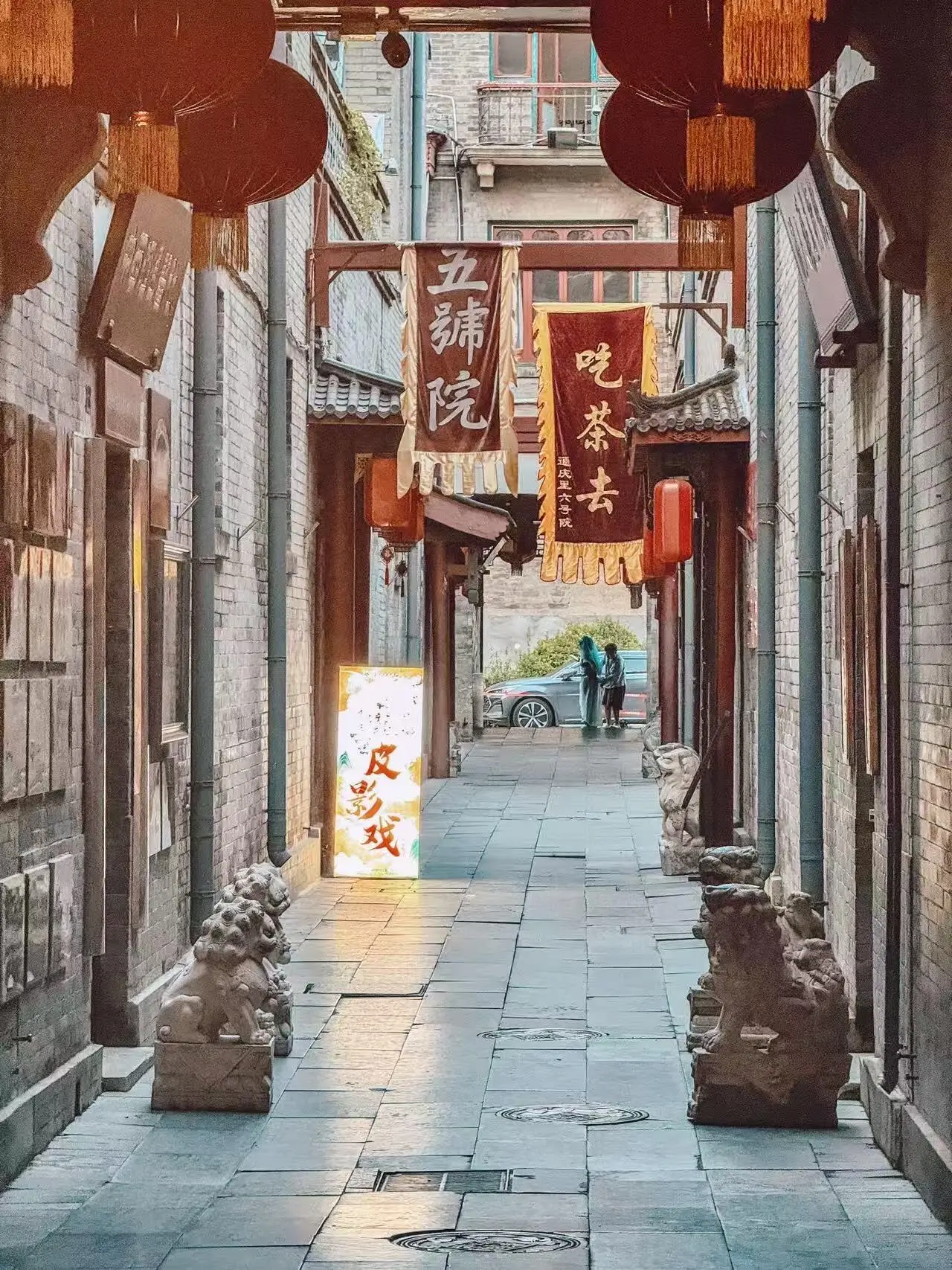 Traditional alley in Tianjin Ancient Culture Street featuring old-style buildings, shop signs, and a glimpse of local culture