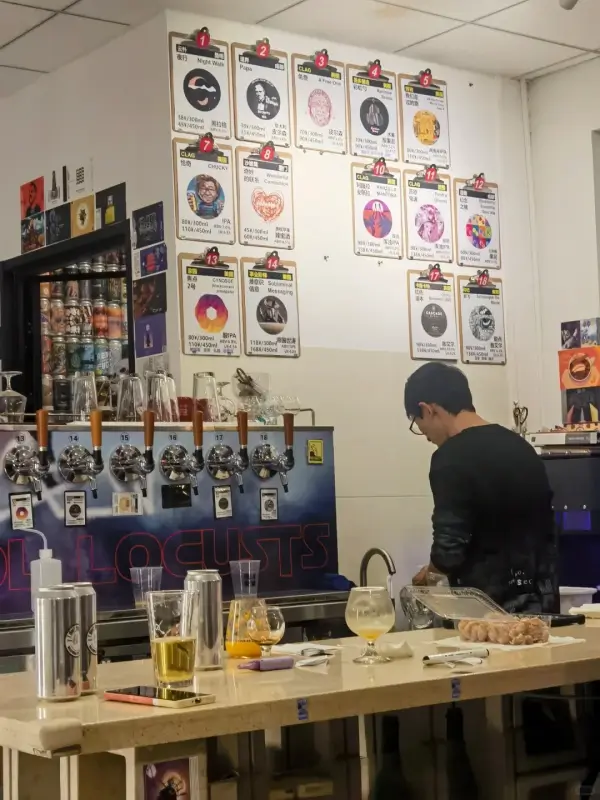 Craft beer taps behind the bar at Locusts Brewing Beijing