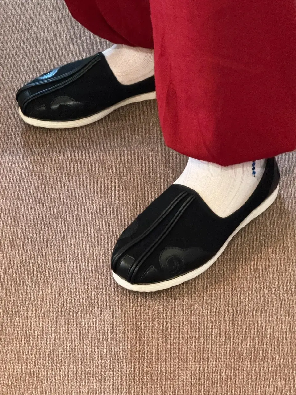Traditional black Old Beijing cloth shoes worn with everyday outfit, showcasing minimalist design and comfort for hutong walking.