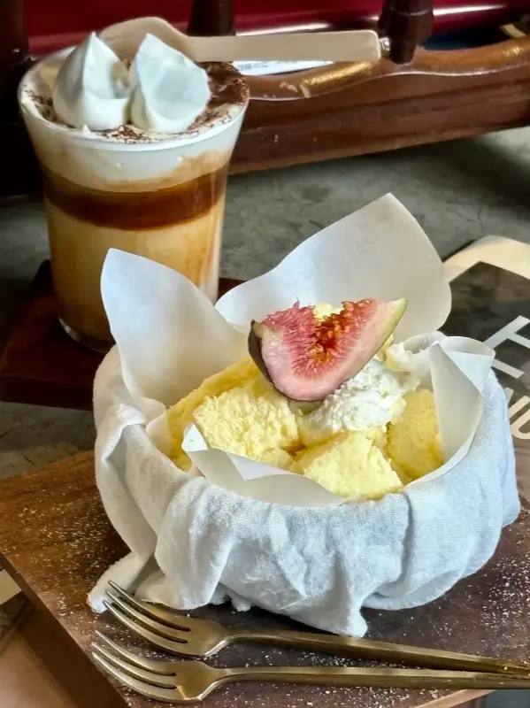 Close view of soft saffron cheesecake served with coffee