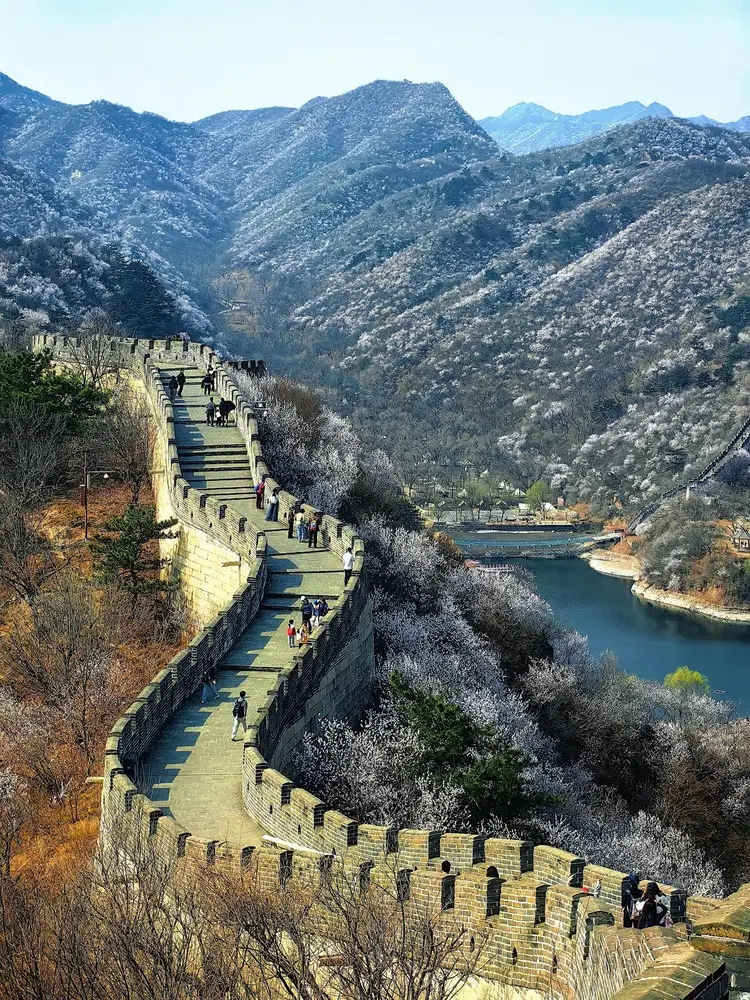 Huanghuacheng Water Great Wall with the wall running alongside the lake and spring blossoms, offering a unique Beijing Great Wall landscape where mountains meet water