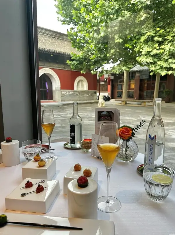 Desserts and drinks at a window table overlooking the temple courtyard
