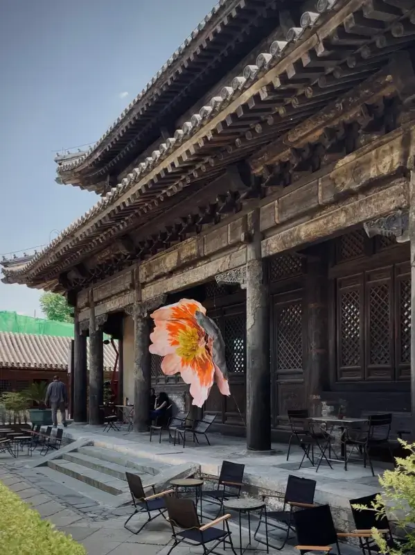 Restored wooden hall and courtyard seating area at Temple Dongjingyuan