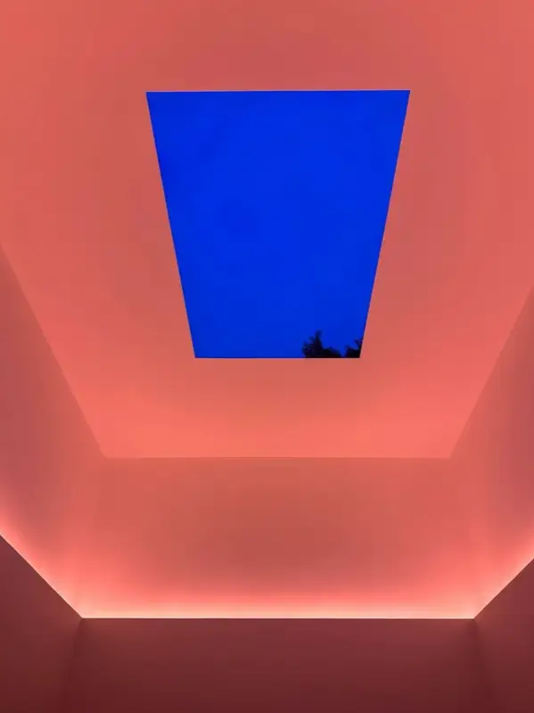 Deep blue evening sky seen through the ceiling opening in the Gathered Sky installation