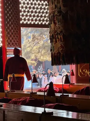 Bite Escape private tour inside Lama Temple with incense, monk, and spiritual atmosphere in Beijing