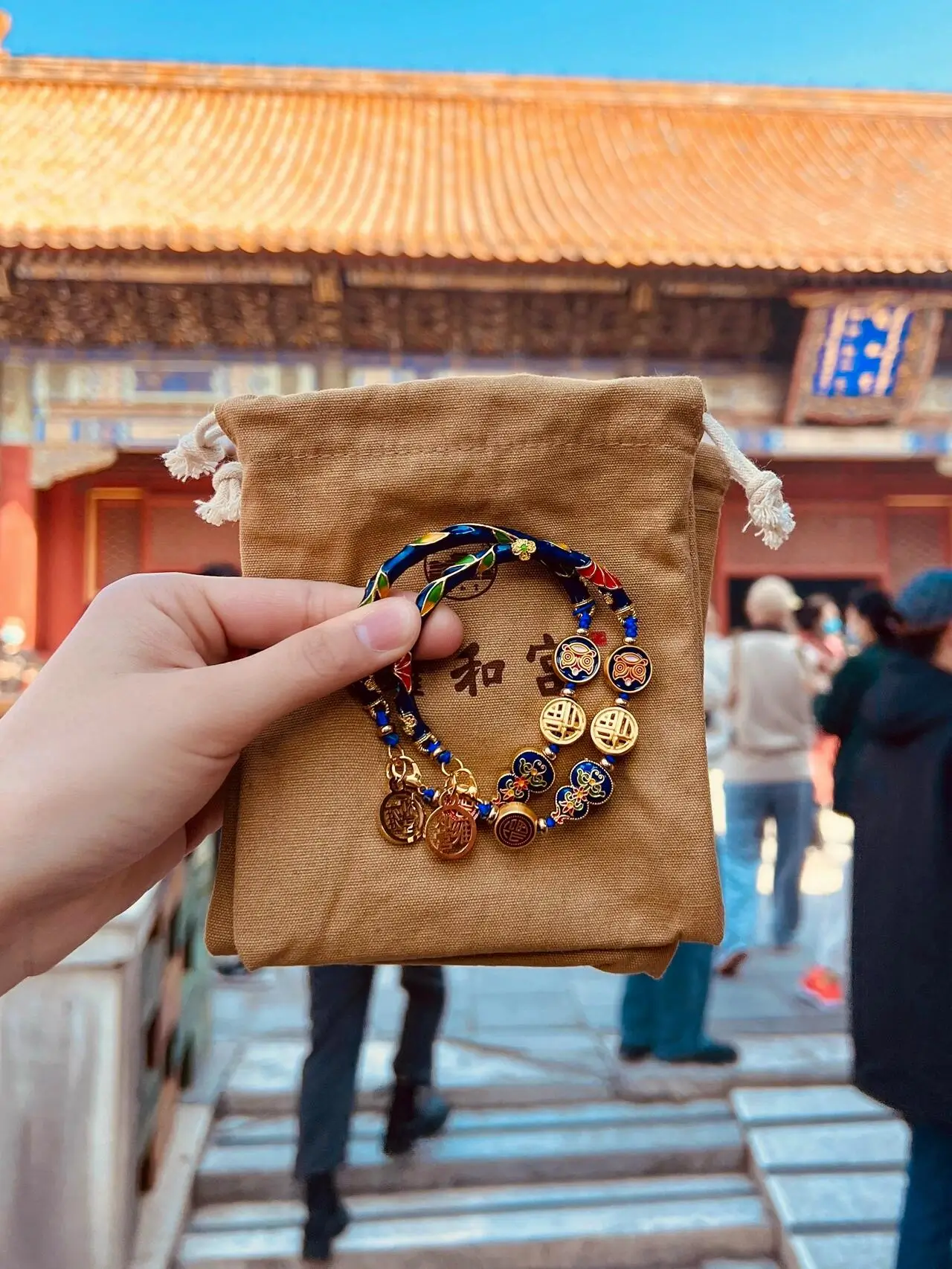 Bracelet purchased at Yonghe Temple, displayed on a pouch in front of the temple entrance, symbolizing blessings and good luck in Beijing temple culture.