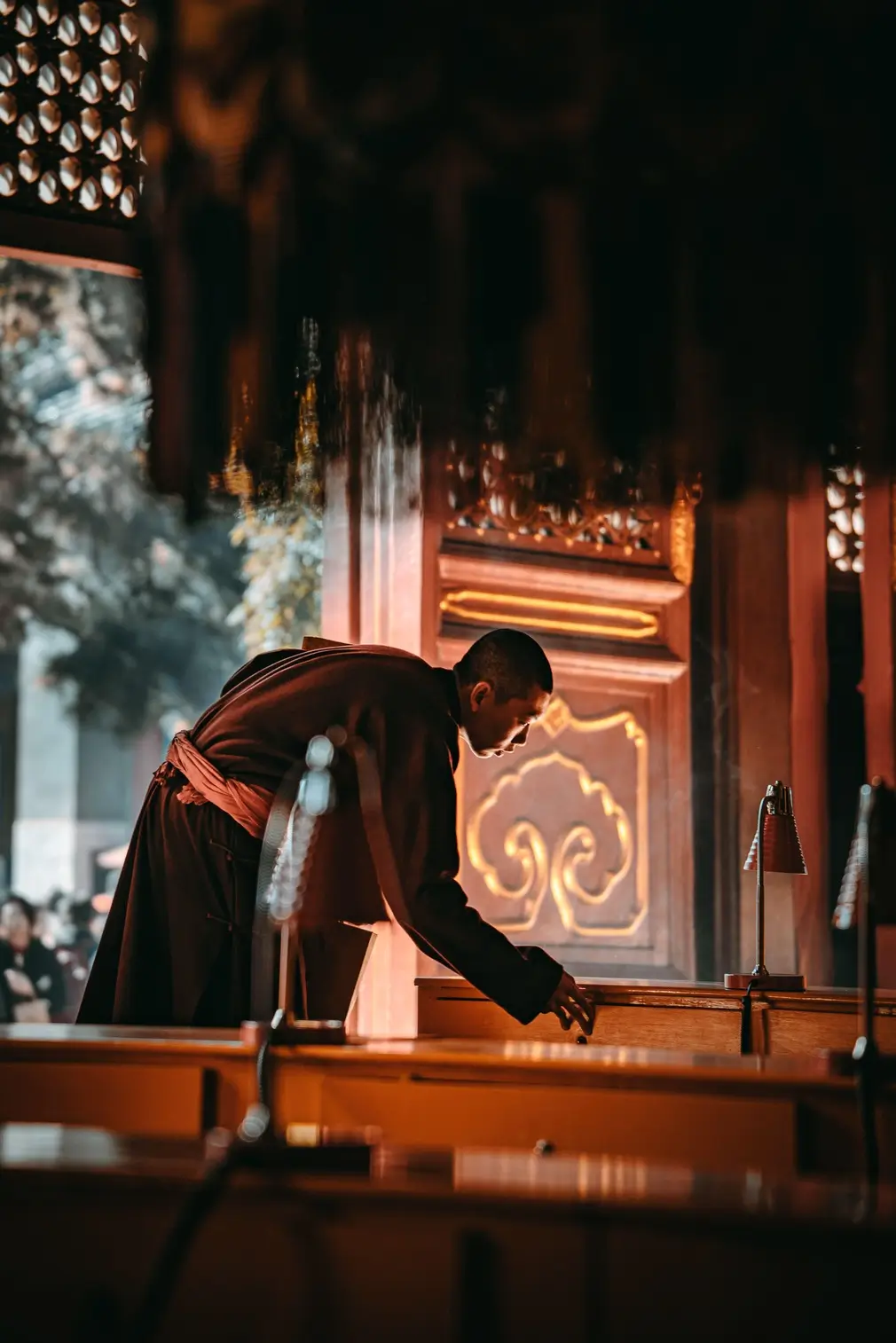A monk inside Lama Temple in Beijing, creating a quiet and peaceful Buddhist temple atmosphere.
