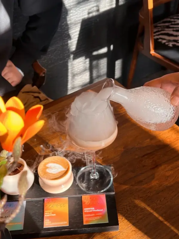 A set of creative drinks served inside Half Coffee, showing the sunlight and hutong atmosphere.