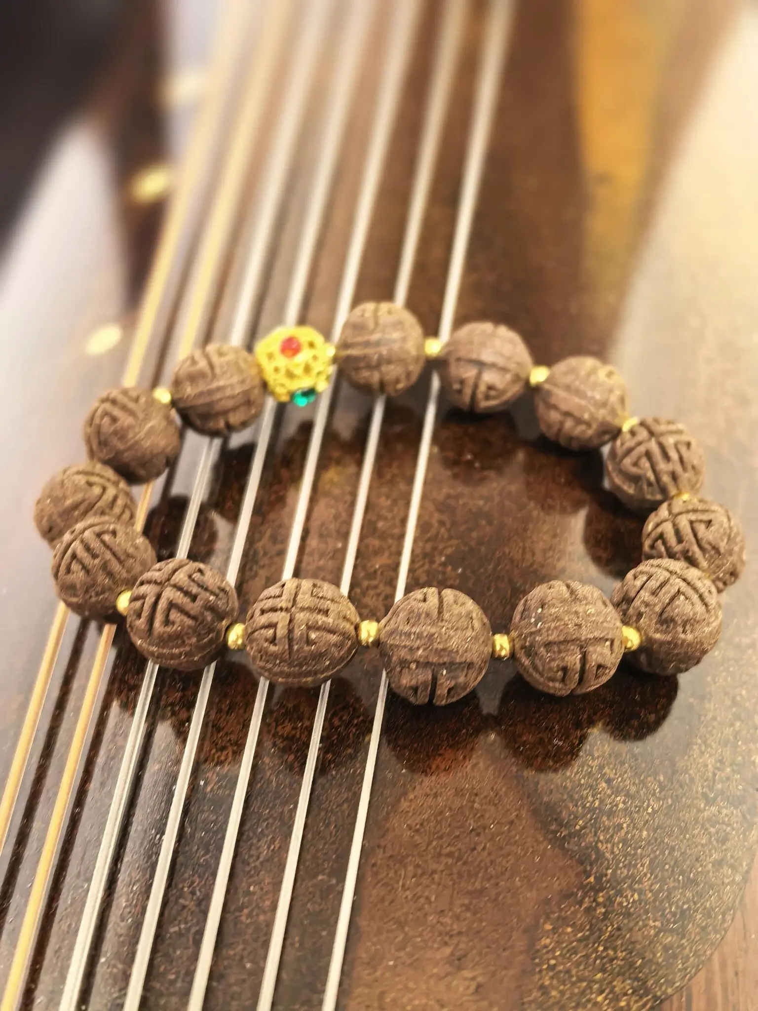 Close-up of Tongrentang herbal bracelet with carved medicinal wood beads, showcasing natural materials and traditional Chinese wellness culture.