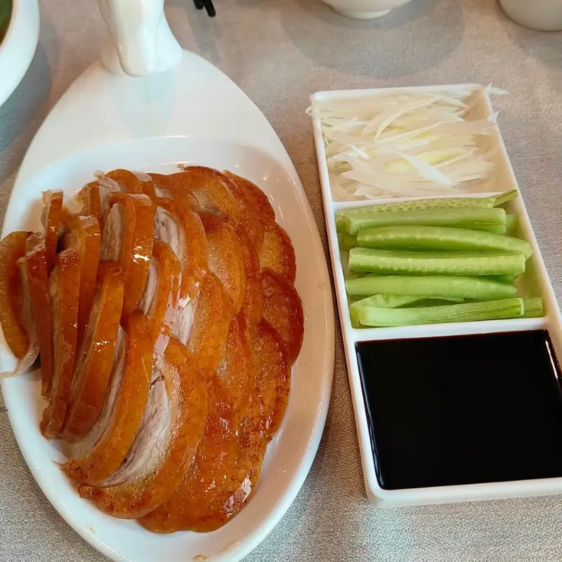 Sliced Peking duck with pancakes and sauce at Bianyifang