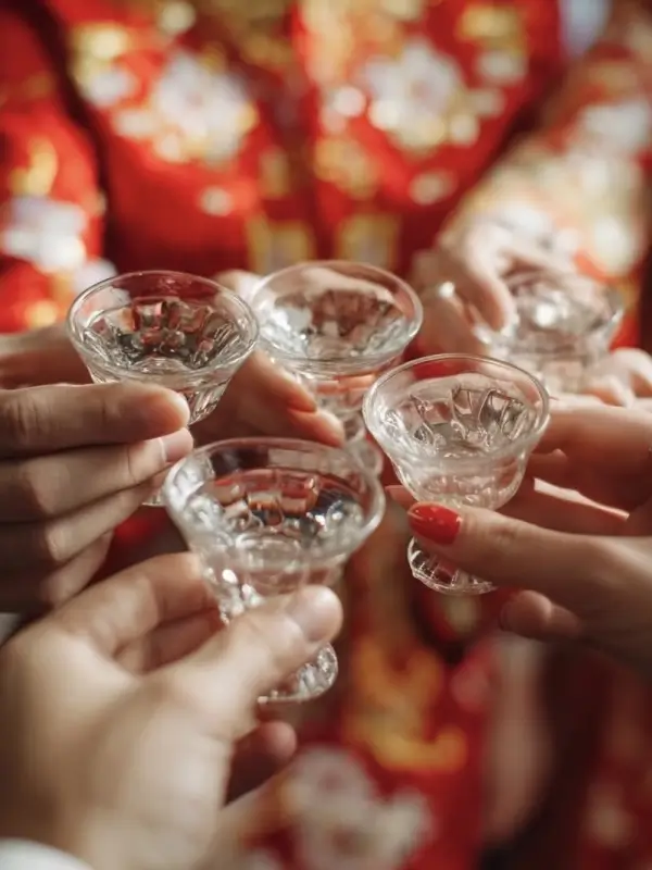 guests saying ganbei with baijiu at a traditional chinese wedding